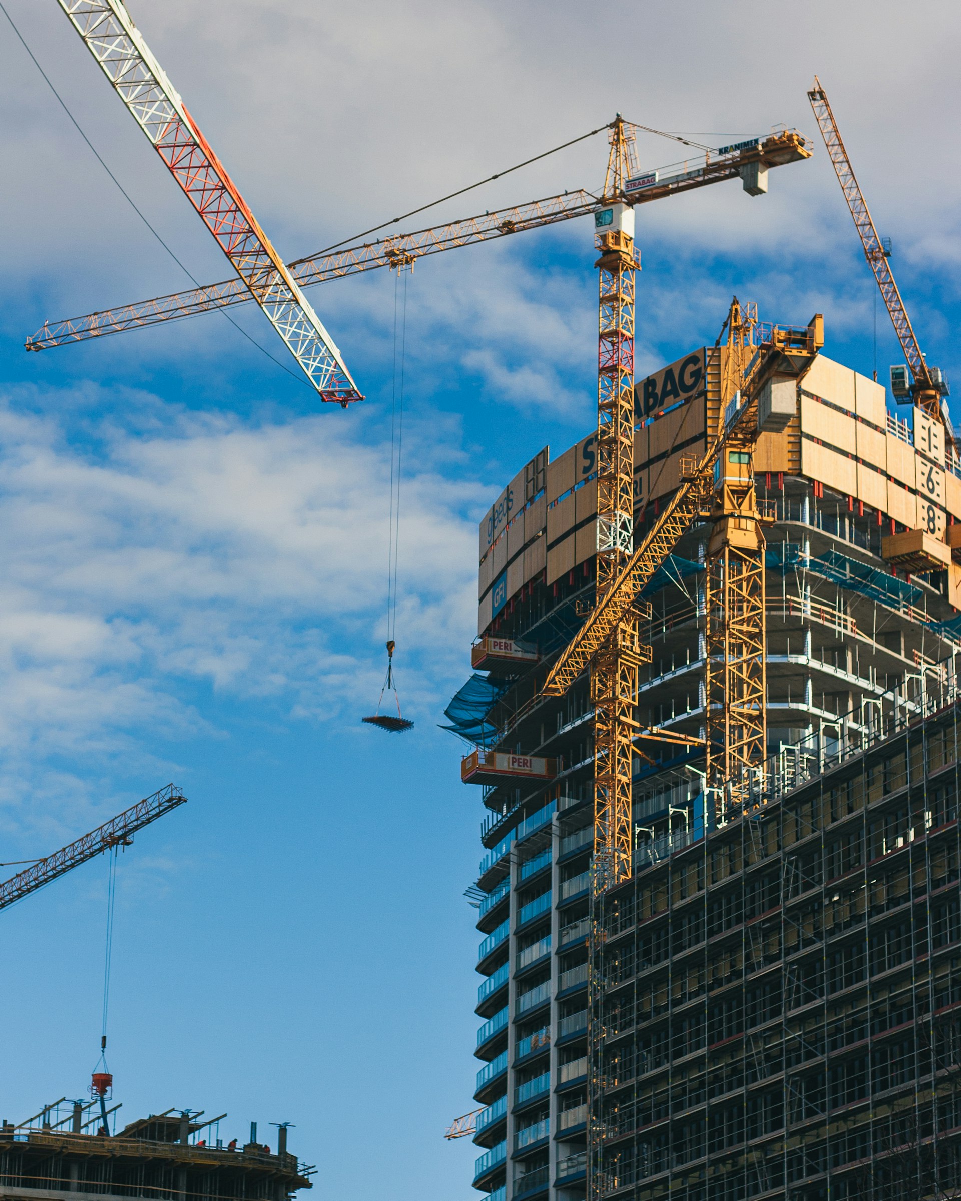 Commercial building under construction with a tower crane and concrete structure